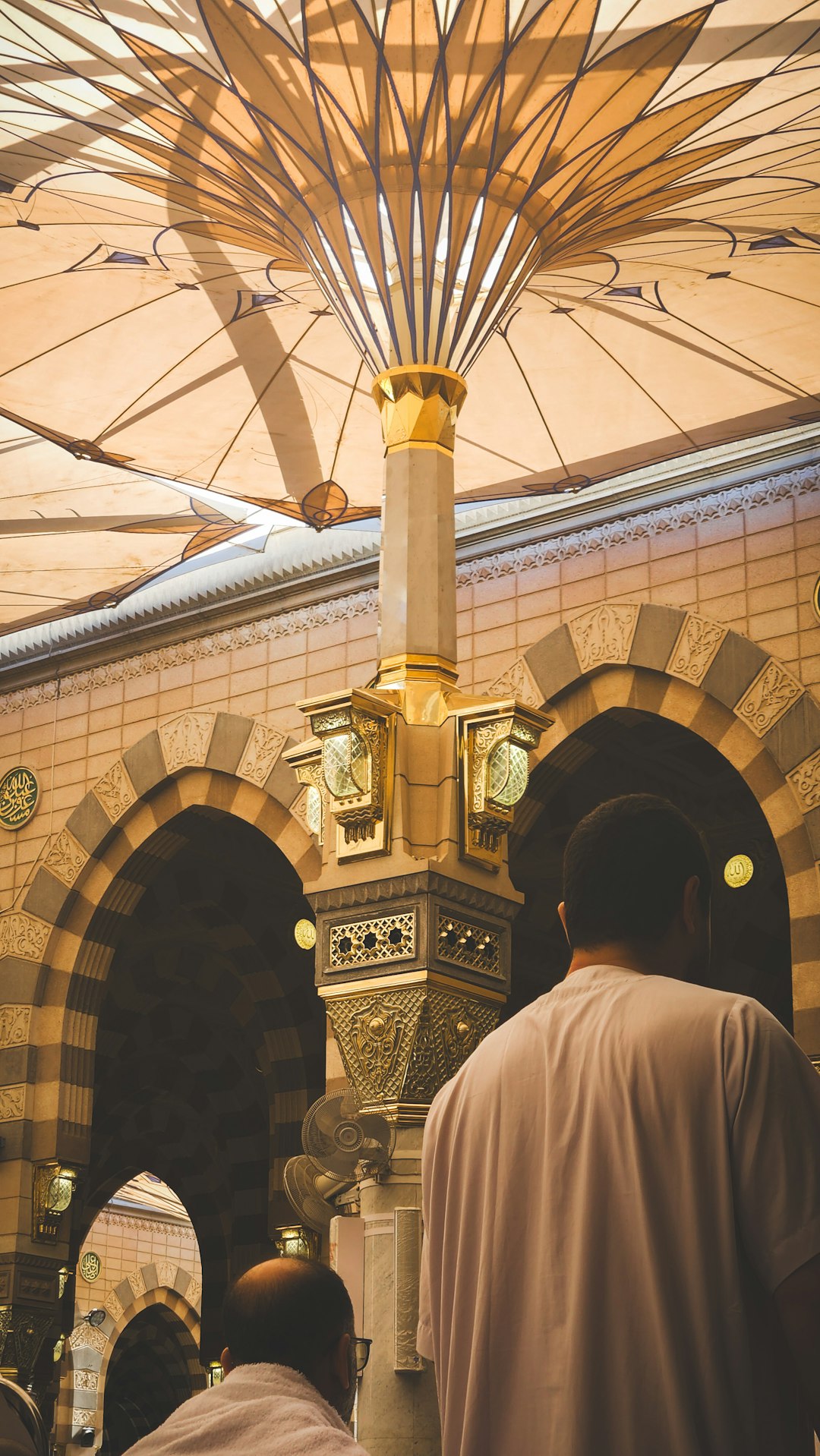 The serene courtyard of Masjid al Nabawi, where faith meets tranquility, and the golden glow of the minarets reflects the warmth of Madinah’s heart.